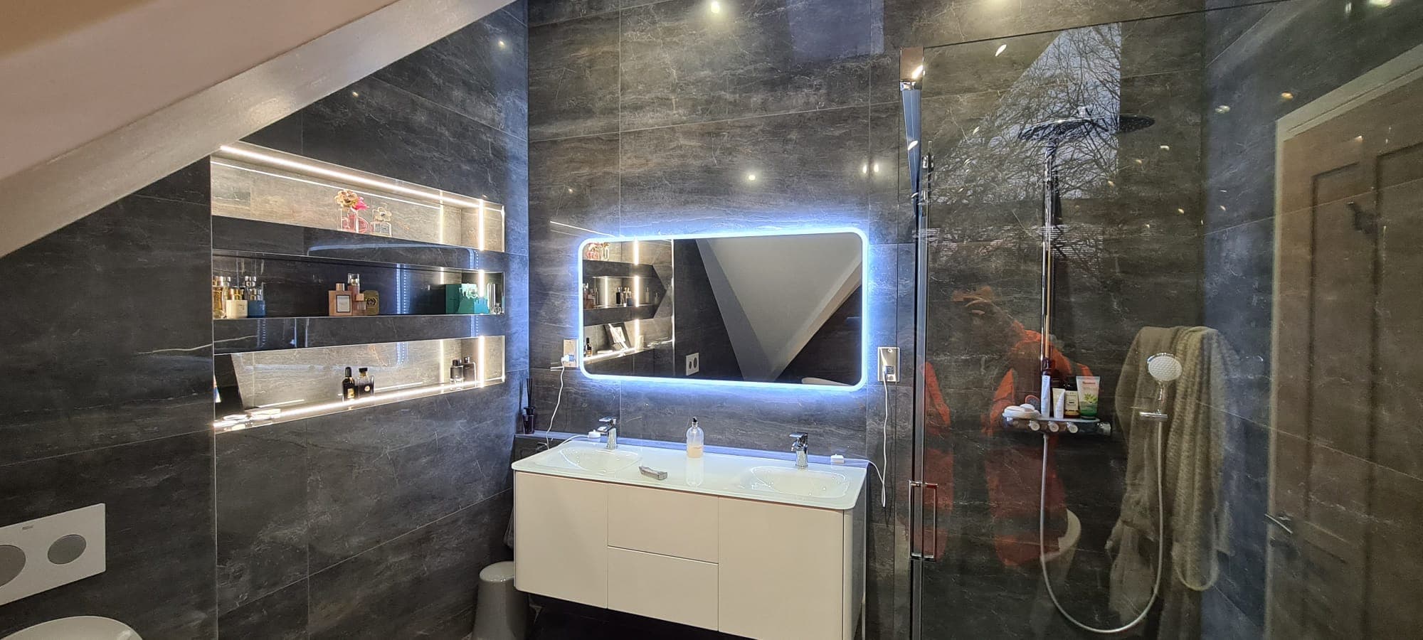 Precision large-format stone tiling in a finished walk-in shower in Hampshire